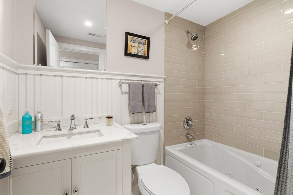 215 Athens Street, Unit 4 Boston, MA 02127 - Photo 13 of 15 a bathroom with a sink a toilet and shower