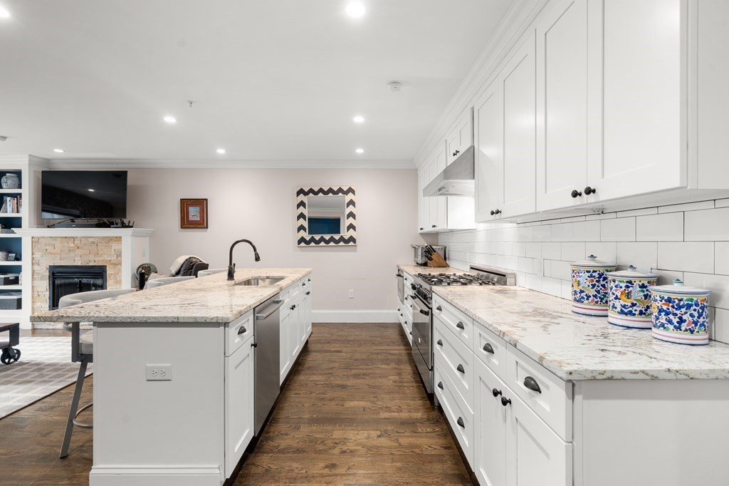 215 Athens Street, Unit 4 Boston, MA 02127 - Photo 2 of 15 a kitchen with a sink stove top oven and refrigerator