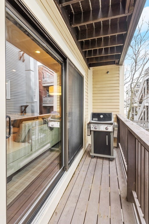 215 Athens Street, Unit 4 Boston, MA 02127 - Photo 9 of 15 a view of a balcony with wooden floor