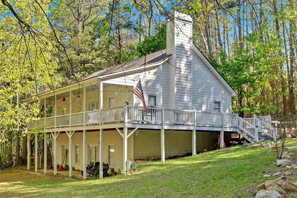 5778 Henderson Mountain Road Jasper, GA 30143 - Photo 1 of 1 a view of a house with a yard and sitting area