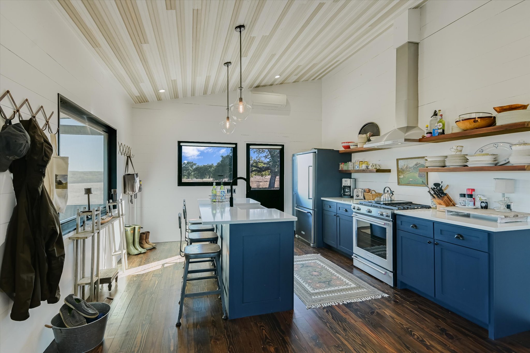 4698 Fischer Store Road Wimberley, TX 78676 - Photo 10 of 28 Gleaming hardwood floors and an oversized central island anchors this airy kitchen space.