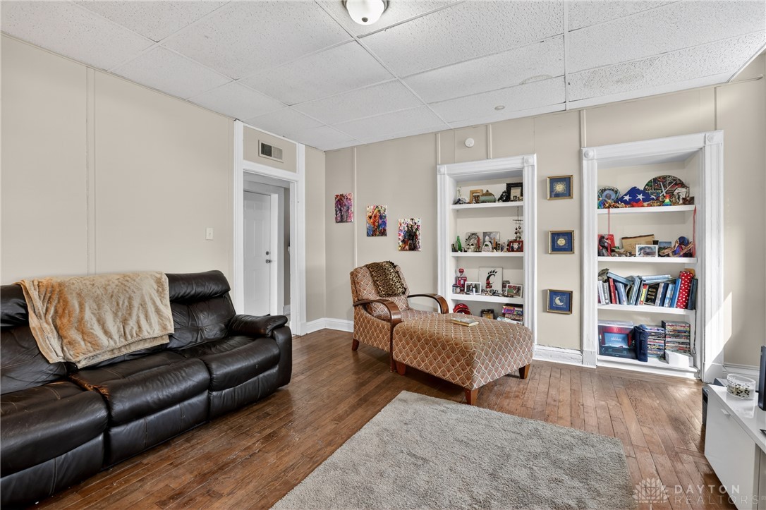 7045-7049 Montgomery Road Cincinnati, OH 45236 - Photo 58 of 68 This inviting living space features built-in shelving and classic wood flooring.