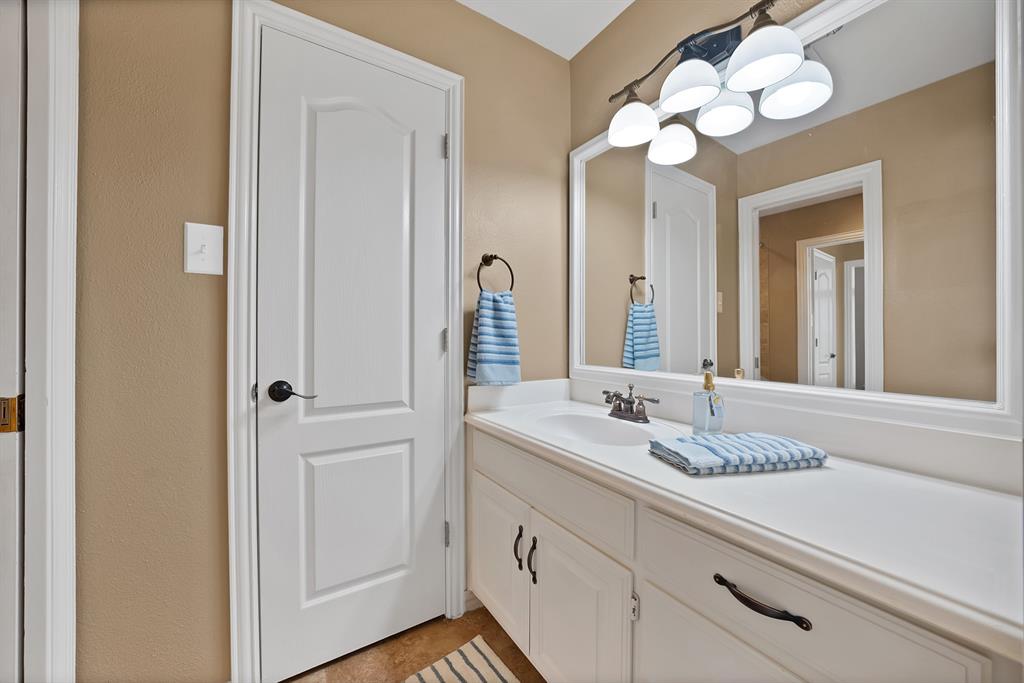 1110 McCampbell Road Mansfield, TX 76063 - Photo 27 of 39 a bathroom with a sink vanity and a mirror