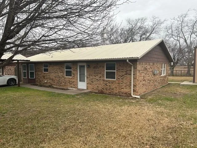 a front view of a house with a garden and yard