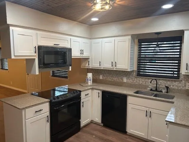 a kitchen with a sink stove and microwave