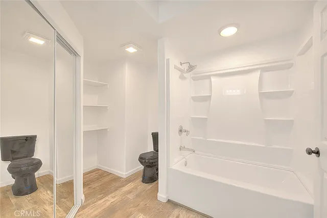 a bathroom with a bathtub and a shower