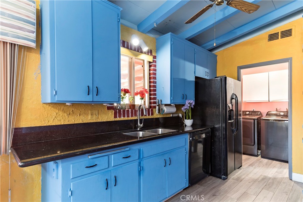 9417 Mango Avenue Fontana, CA 92335 - Photo 12 of 41 a kitchen with a refrigerator and a sink