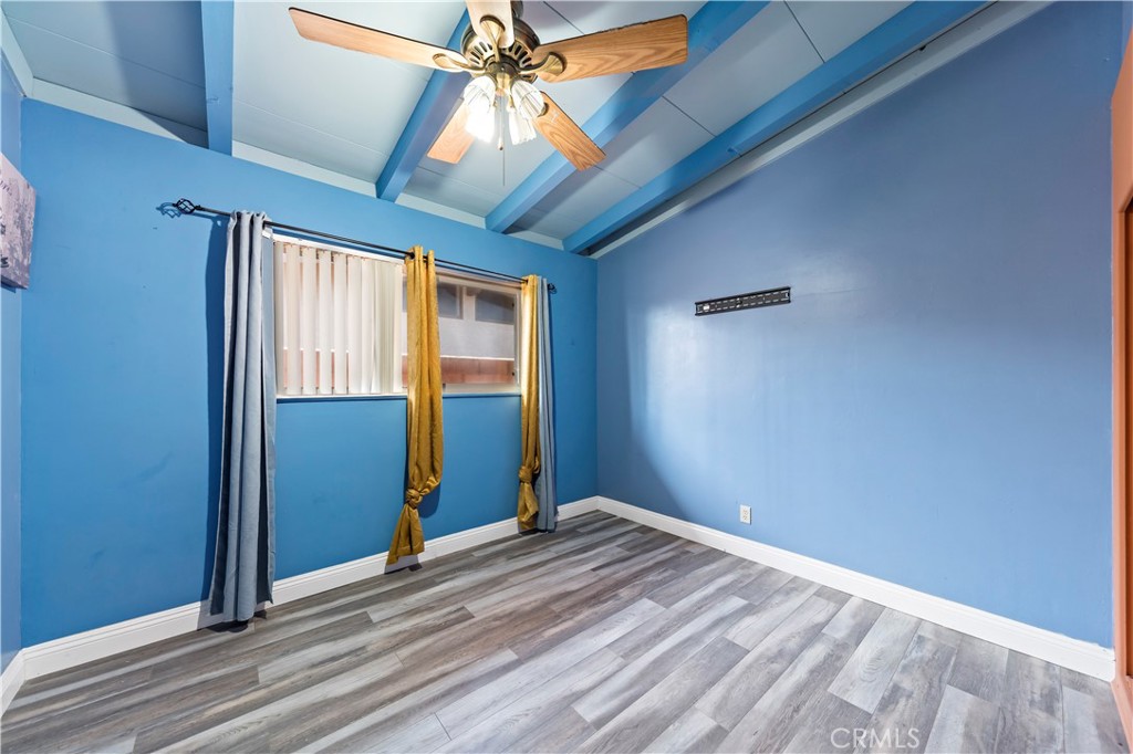 9417 Mango Avenue Fontana, CA 92335 - Photo 18 of 41 a view of an empty room with window and wooden floor