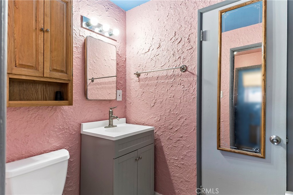 9417 Mango Avenue Fontana, CA 92335 - Photo 19 of 41 a bathroom with a sink and a mirror