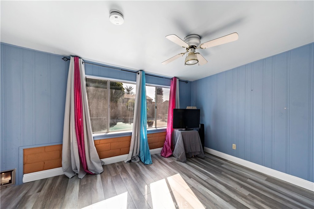 9417 Mango Avenue Fontana, CA 92335 - Photo 23 of 41 a view of room with wooden floor and ceiling fan