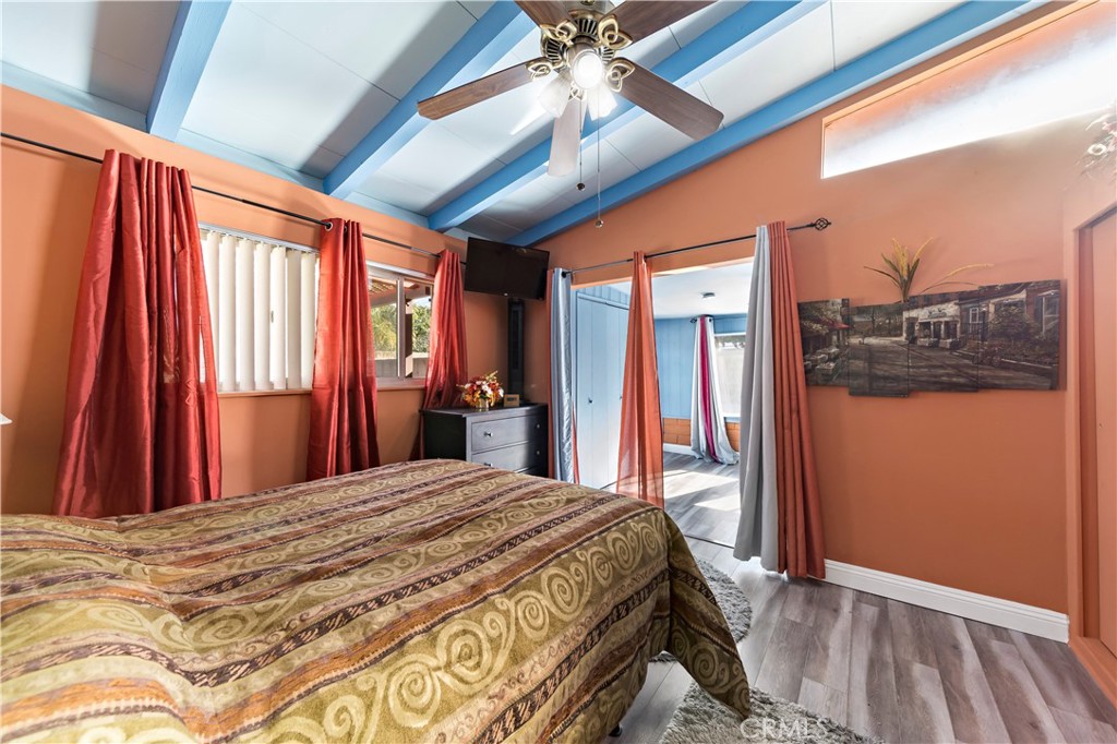 9417 Mango Avenue Fontana, CA 92335 - Photo 26 of 41 a bedroom with a large bed and a chandelier