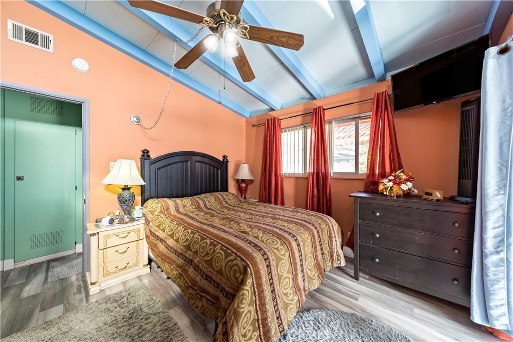 9417 Mango Avenue Fontana, CA 92335 - Photo 27 of 41 a bedroom with a bed and a mirror