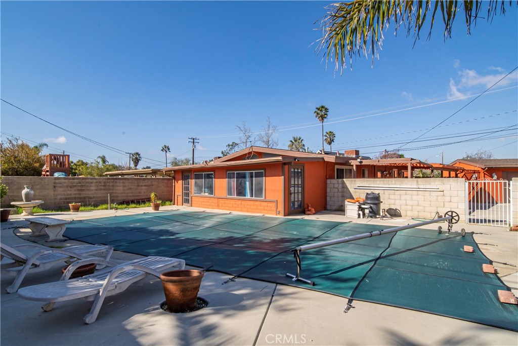 9417 Mango Avenue Fontana, CA 92335 - Photo 29 of 41 a view of a swimming pool with a lounge chairs