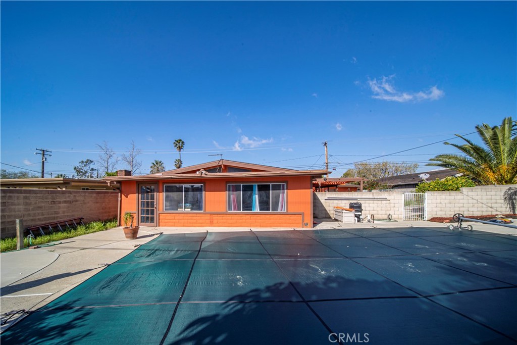 9417 Mango Avenue Fontana, CA 92335 - Photo 30 of 41 a front view of a house with a yard and potted plants