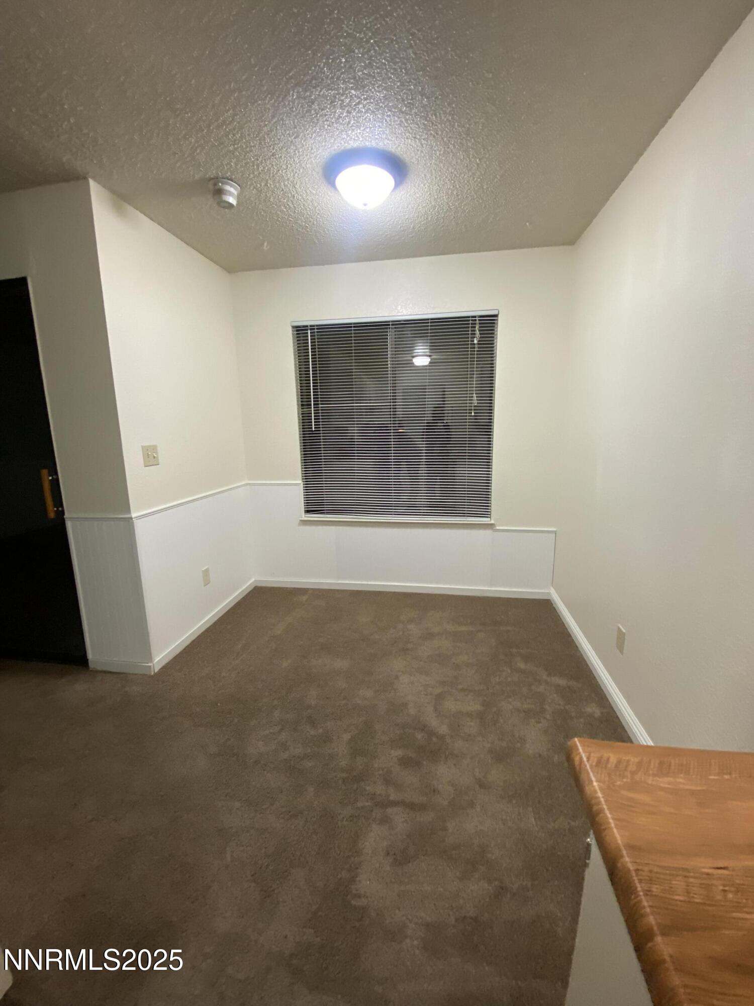 3865 East Leonesio Drive, Unit H1 Reno, NV 89512 - Photo 12 of 12 an empty room with a window