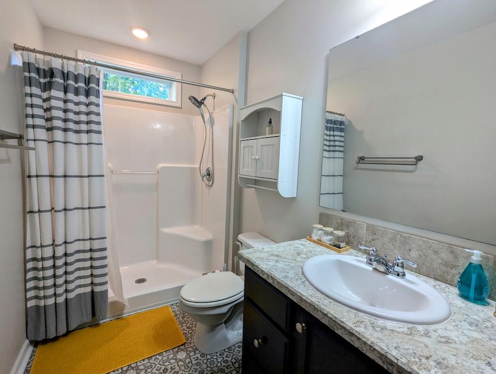 1251 Epperly Mill Road Southwest Floyd, VA 24091 - Photo 14 of 20 a bathroom with a granite countertop sink toilet and shower