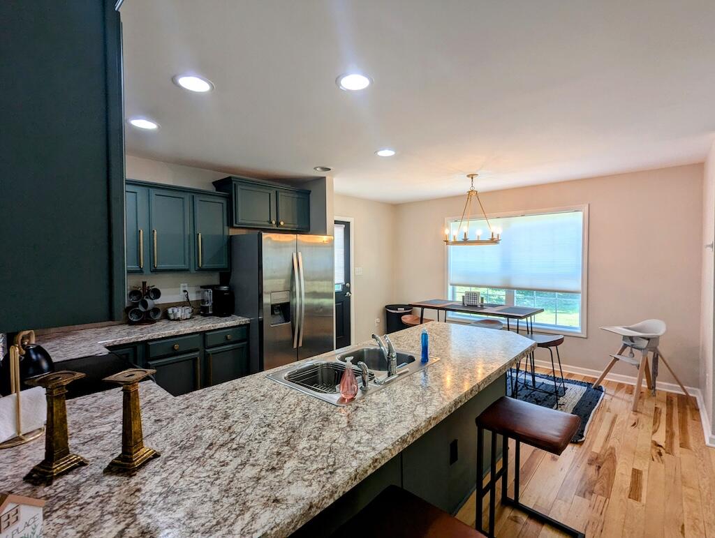 1251 Epperly Mill Road Southwest Floyd, VA 24091 - Photo 10 of 20 a kitchen with a table chairs stove refrigerator and sink
