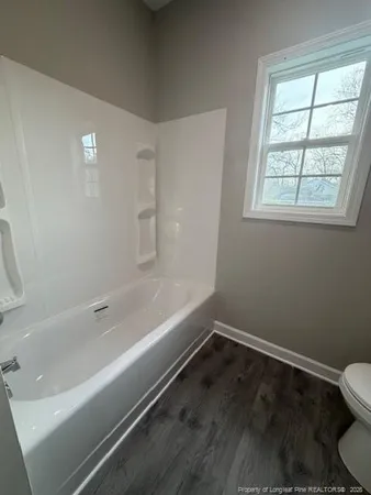 a bathroom with a bathtub and a window