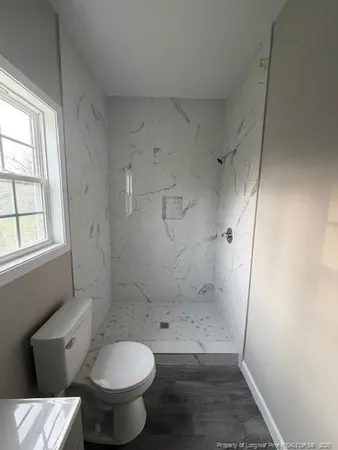 a bathroom with a toilet and a shower