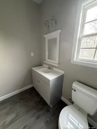 a white toilet sitting next to a bathroom sink