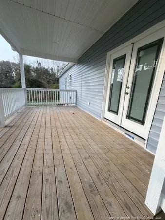 a view of outdoor space with wooden floor and fence