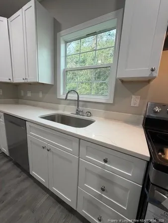 a kitchen with a sink and cabinets