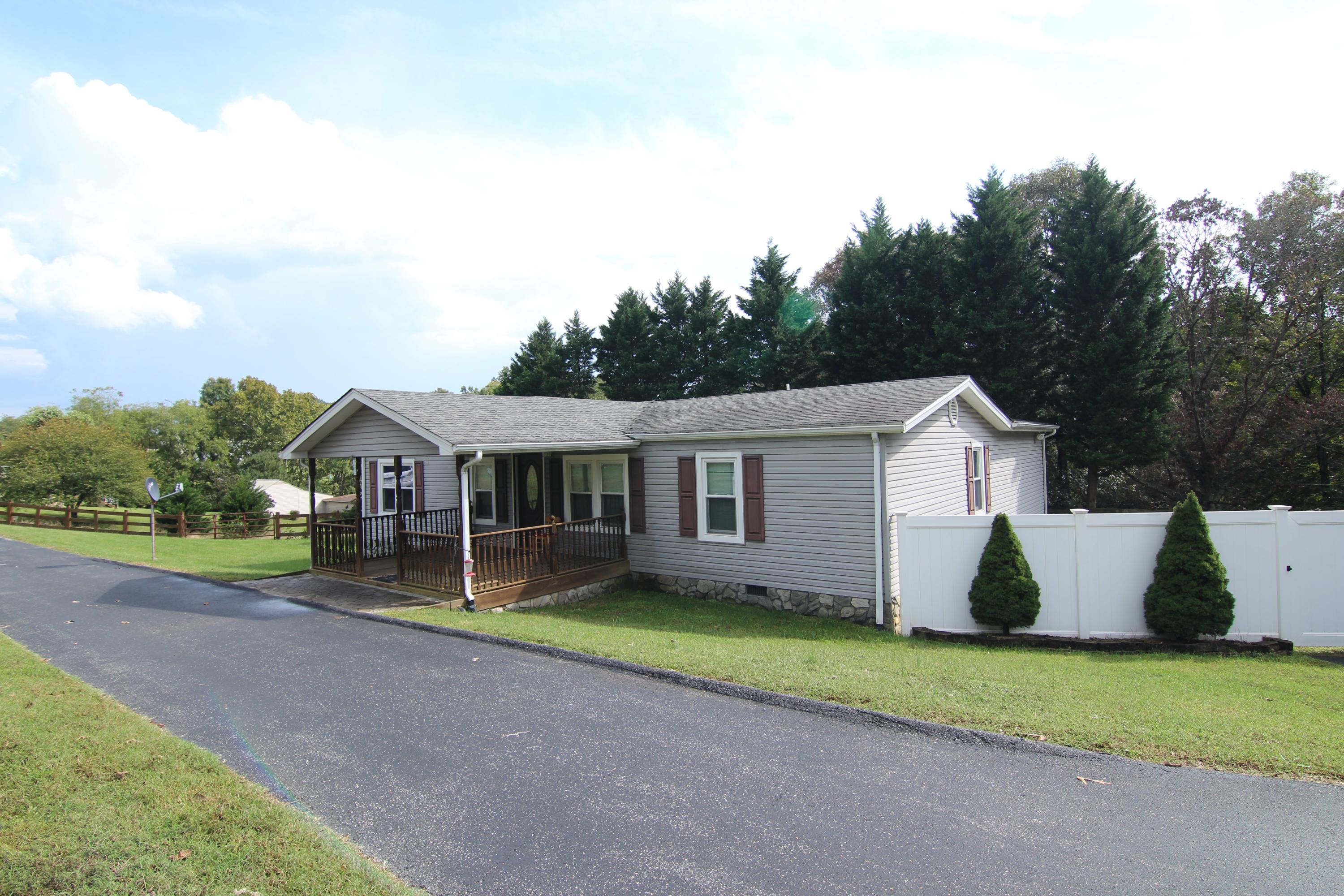 6773 Goodview Road Goodview, VA 24095 - Photo 1 of 43 a house that has a big yard with wooden fence