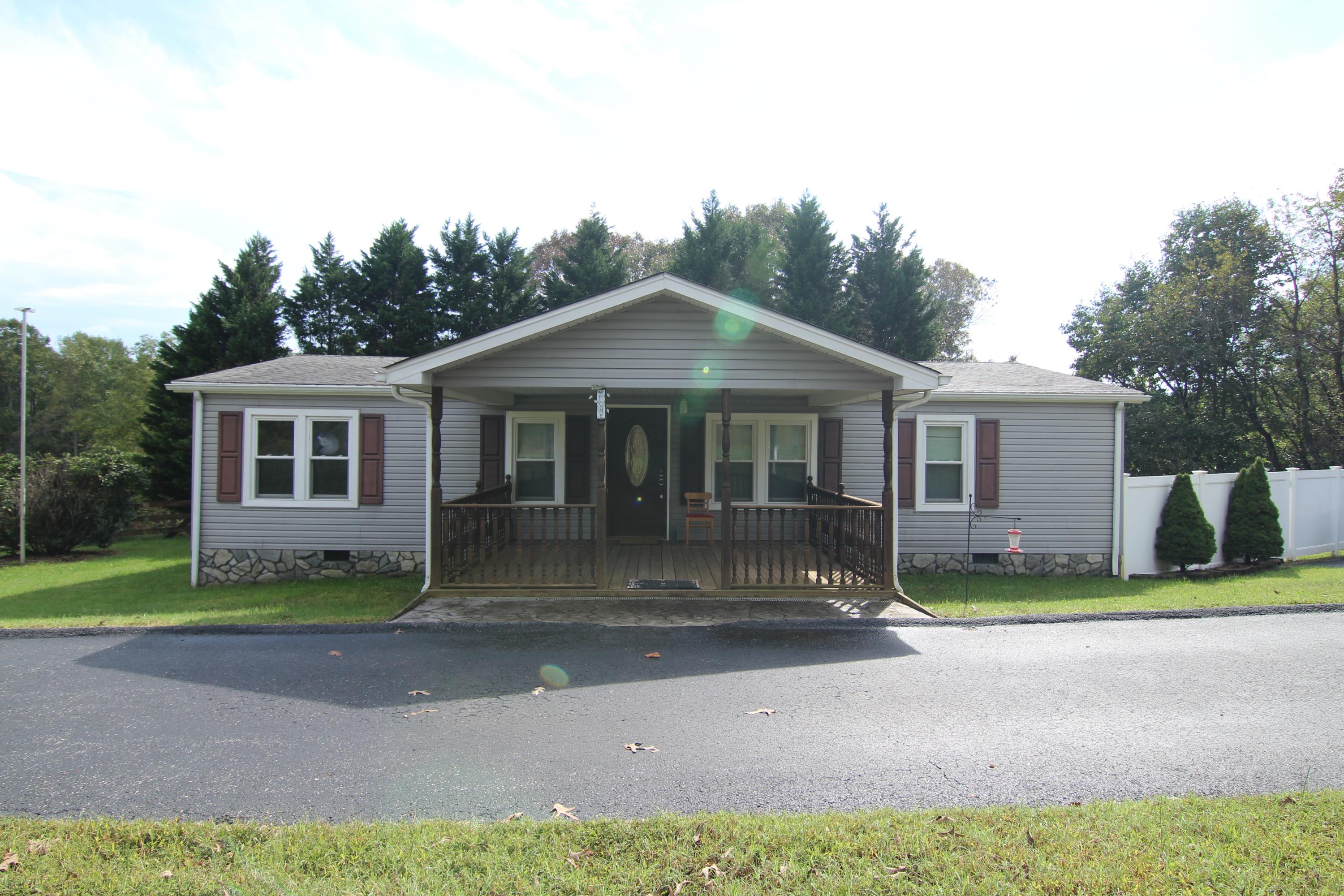 6773 Goodview Road Goodview, VA 24095 - Photo 2 of 43 a front view of a house with a yard and garage