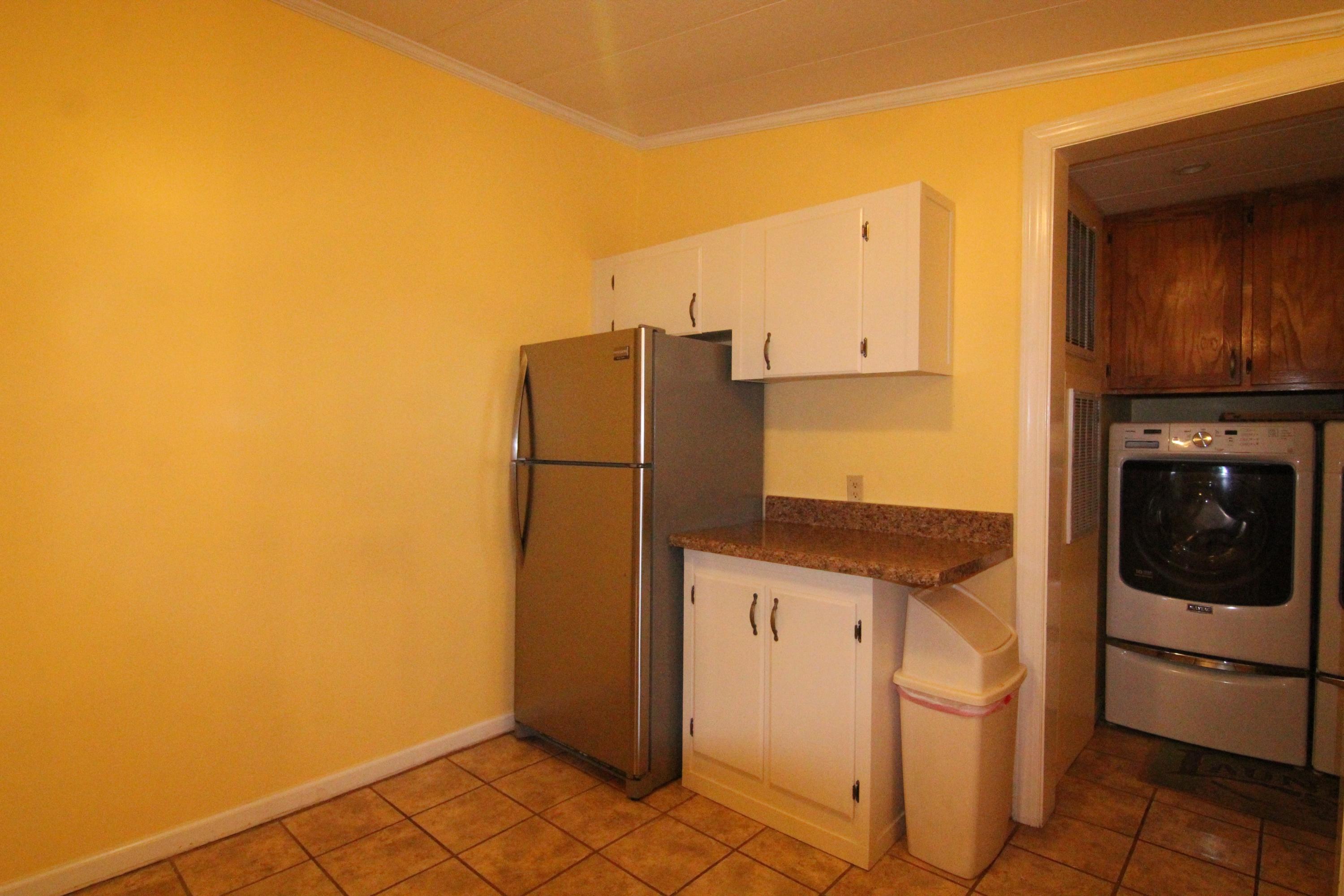 6773 Goodview Road Goodview, VA 24095 - Photo 11 of 43 a kitchen with a refrigerator and cabinets