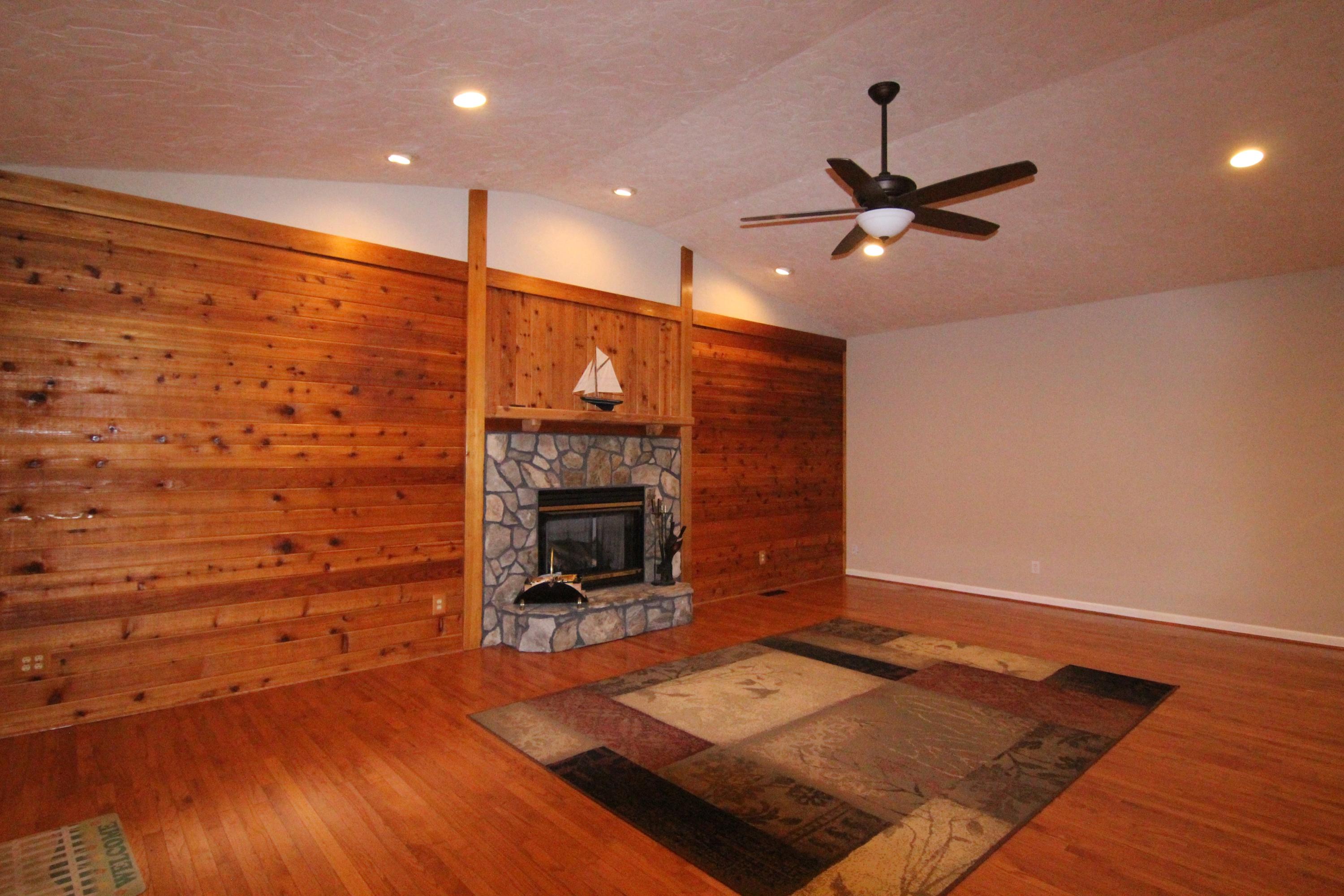 6773 Goodview Road Goodview, VA 24095 - Photo 12 of 43 a living room with hard wood floors and a fireplace
