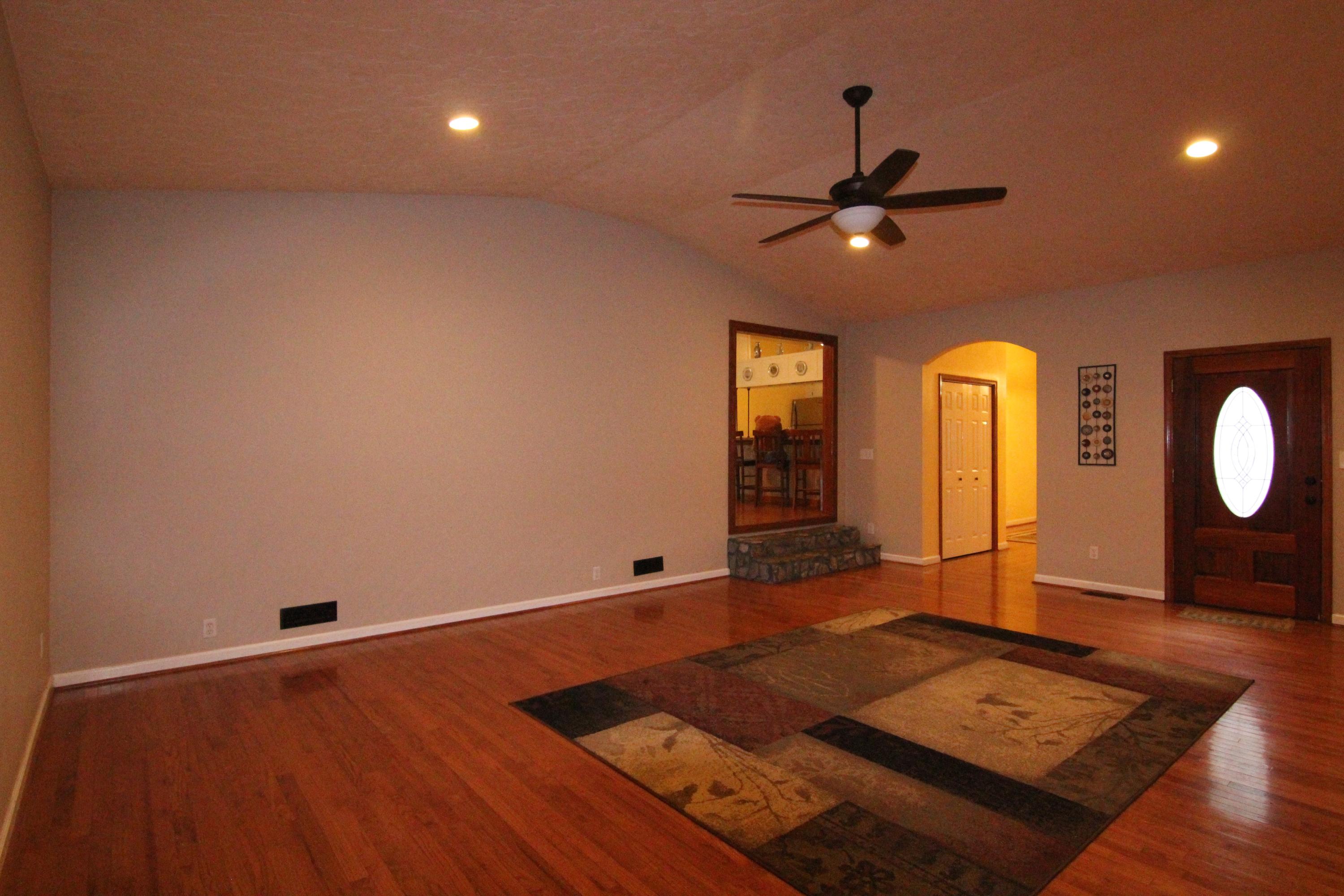 6773 Goodview Road Goodview, VA 24095 - Photo 15 of 43 a living room with hard wood floors and a ceiling fan