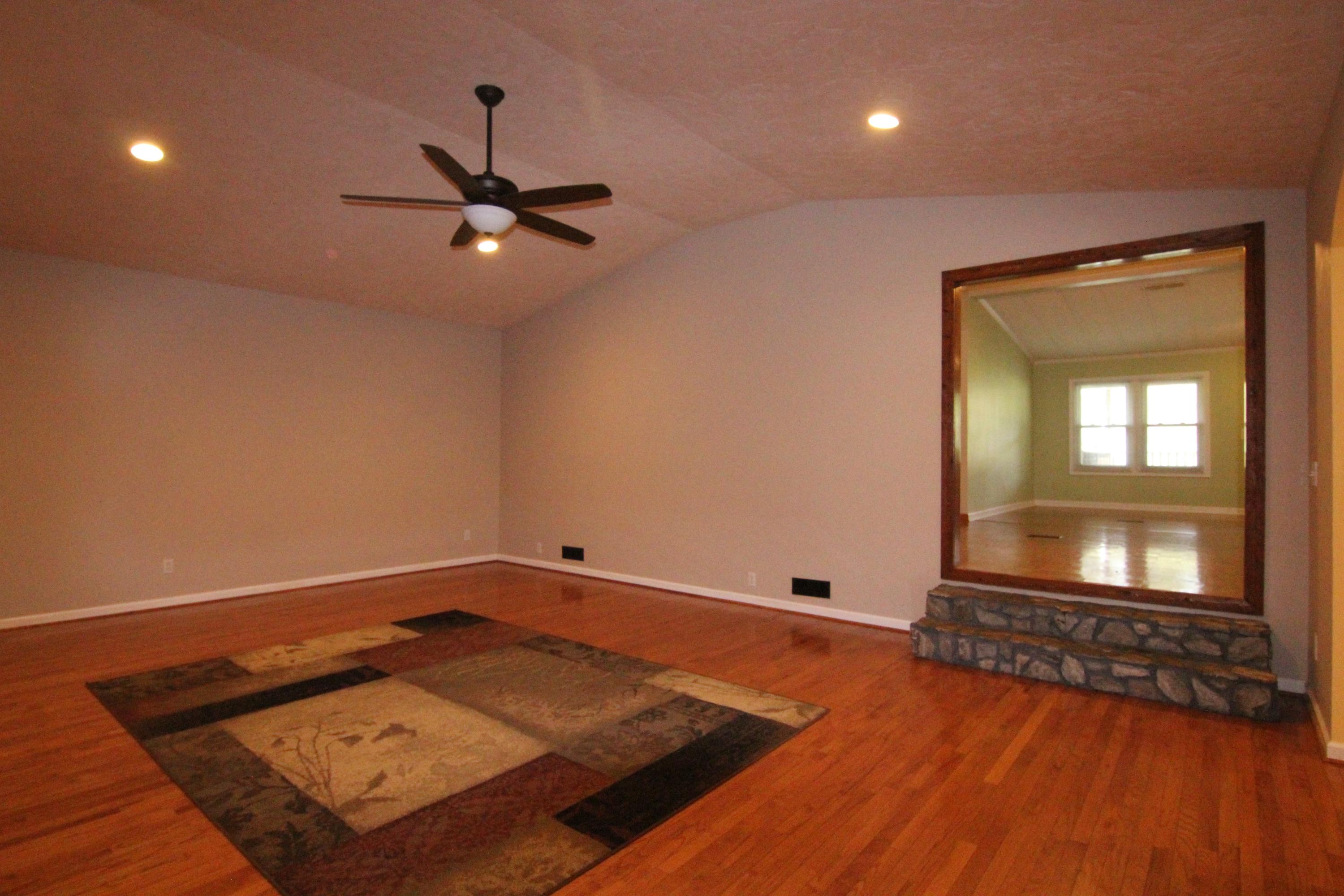 6773 Goodview Road Goodview, VA 24095 - Photo 16 of 43 wooden floor in a hall with a window and a rug