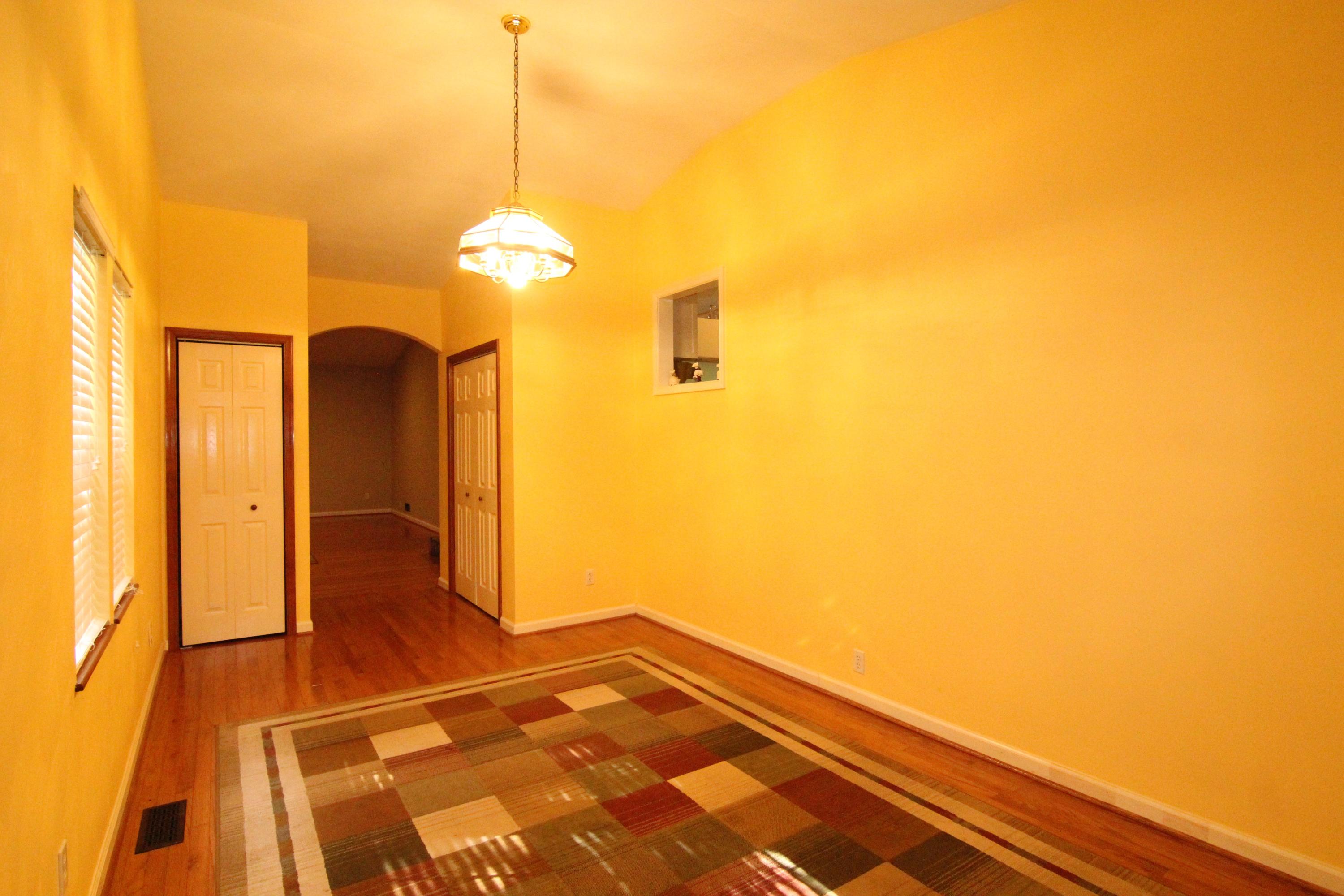 6773 Goodview Road Goodview, VA 24095 - Photo 18 of 43 a bedroom with a bed and a chandelier
