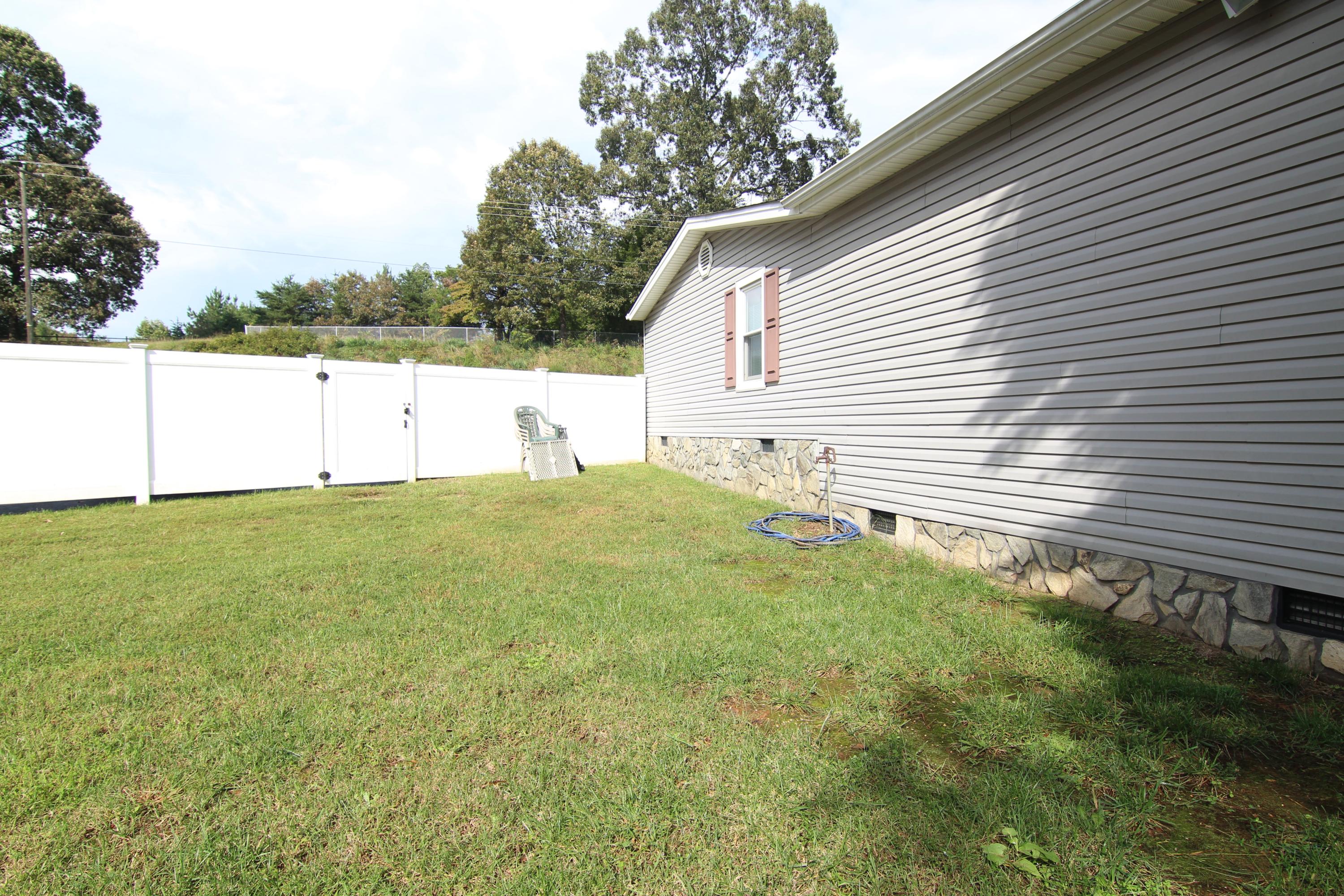 6773 Goodview Road Goodview, VA 24095 - Photo 28 of 43 a view of yard with large trees and a small yard