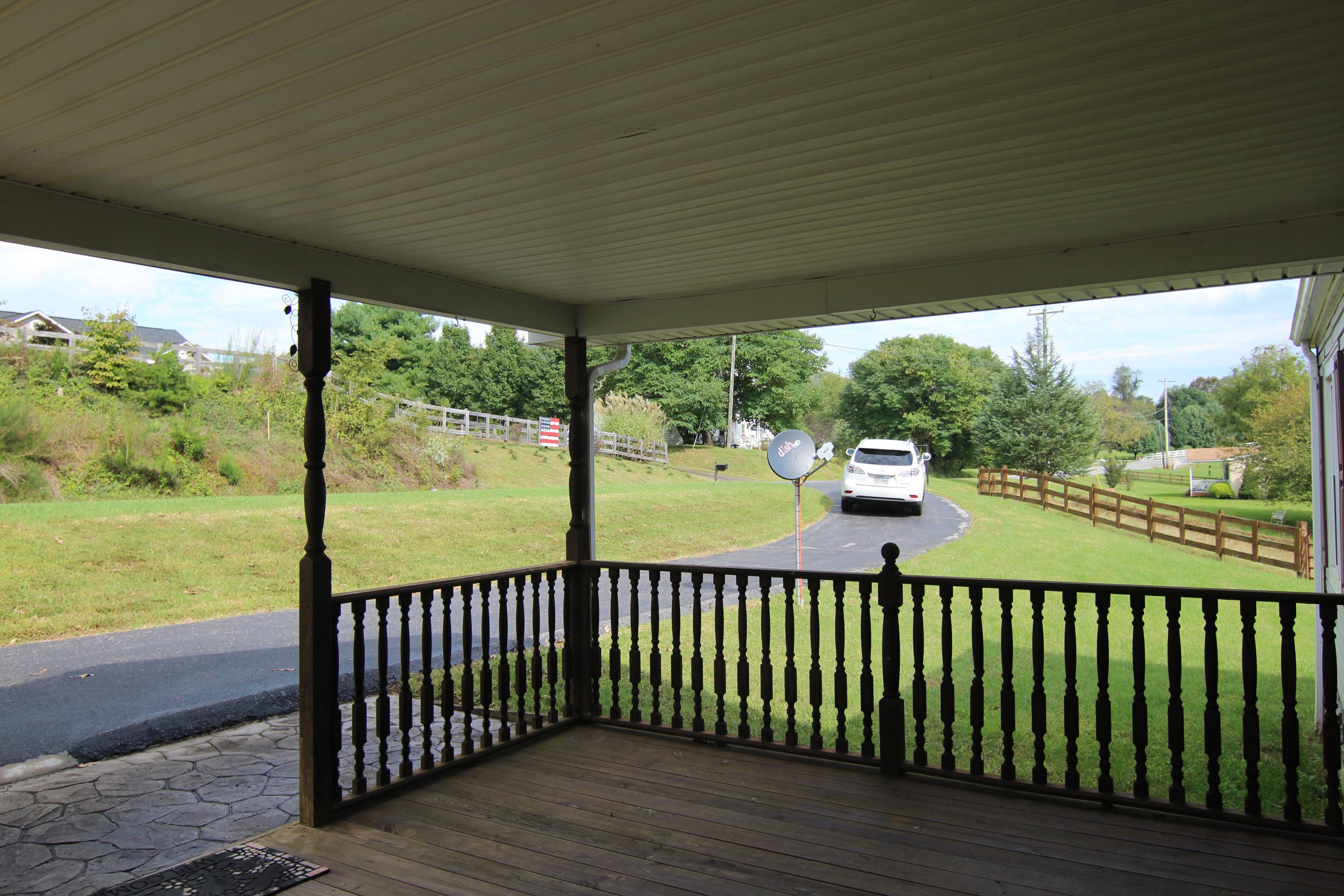 6773 Goodview Road Goodview, VA 24095 - Photo 4 of 43 a view of a porch and a yard