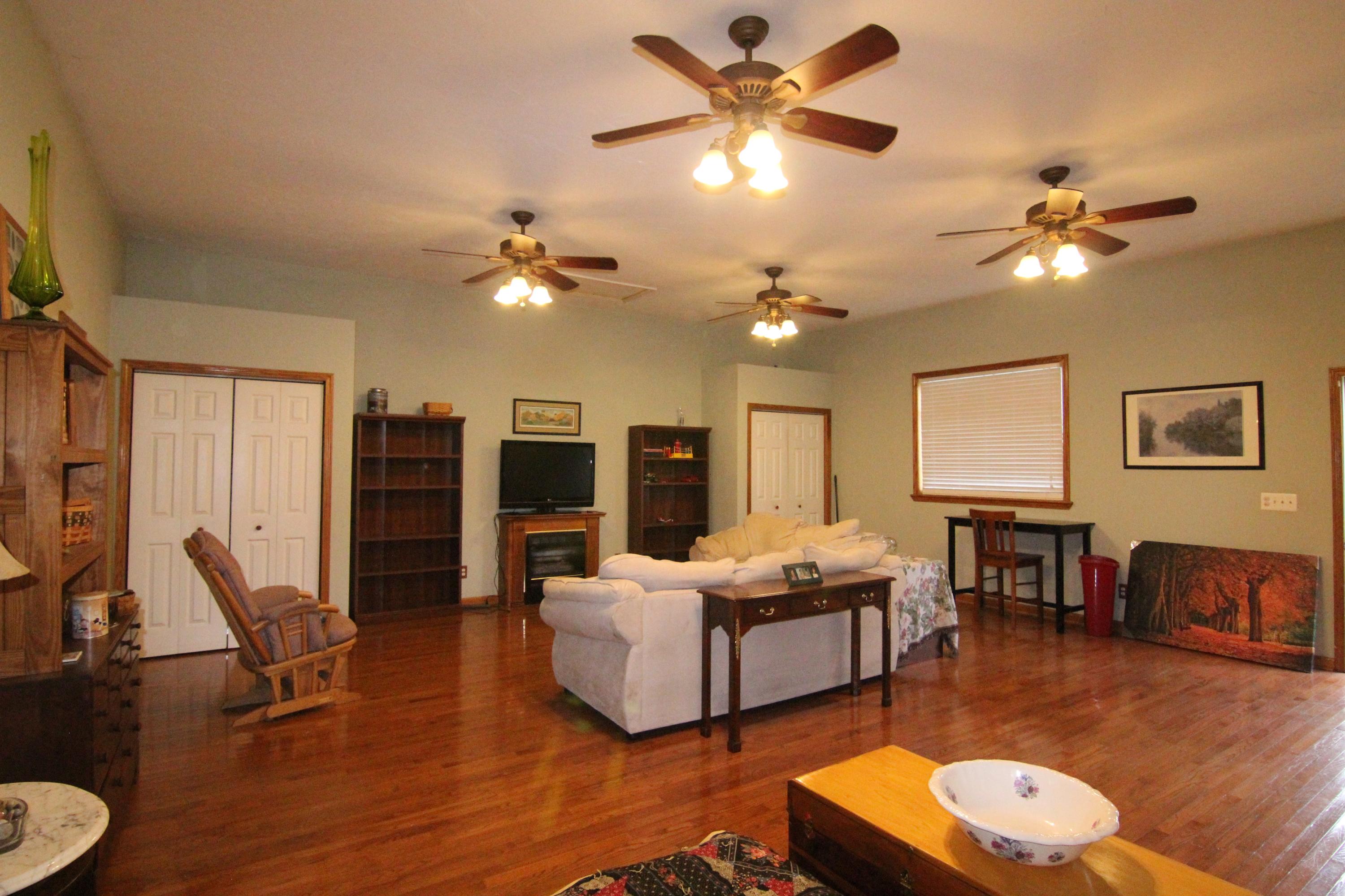 6773 Goodview Road Goodview, VA 24095 - Photo 36 of 43 a living room with furniture a fireplace and a flat screen tv