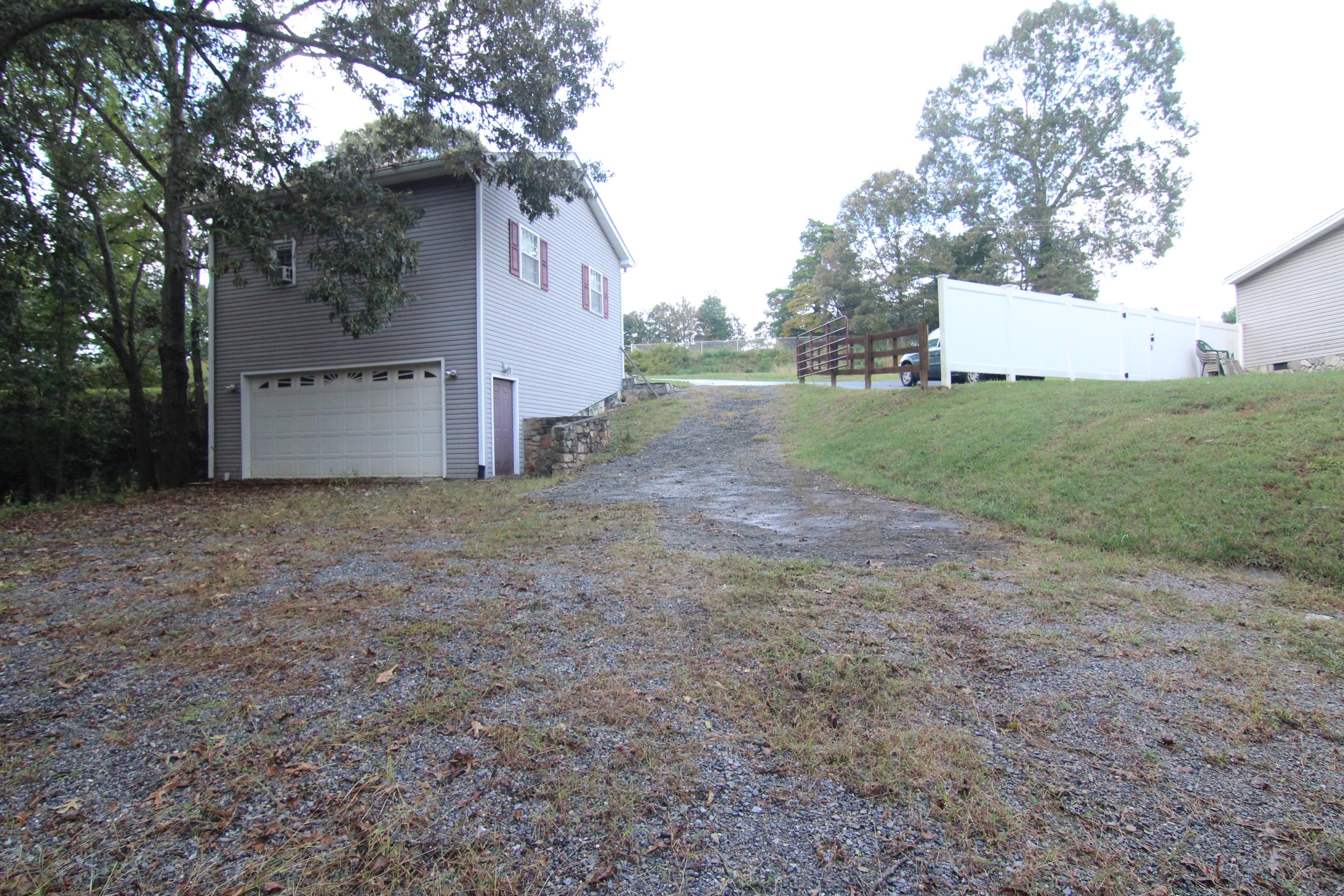 6773 Goodview Road Goodview, VA 24095 - Photo 40 of 43 a view of a house with a yard and garage