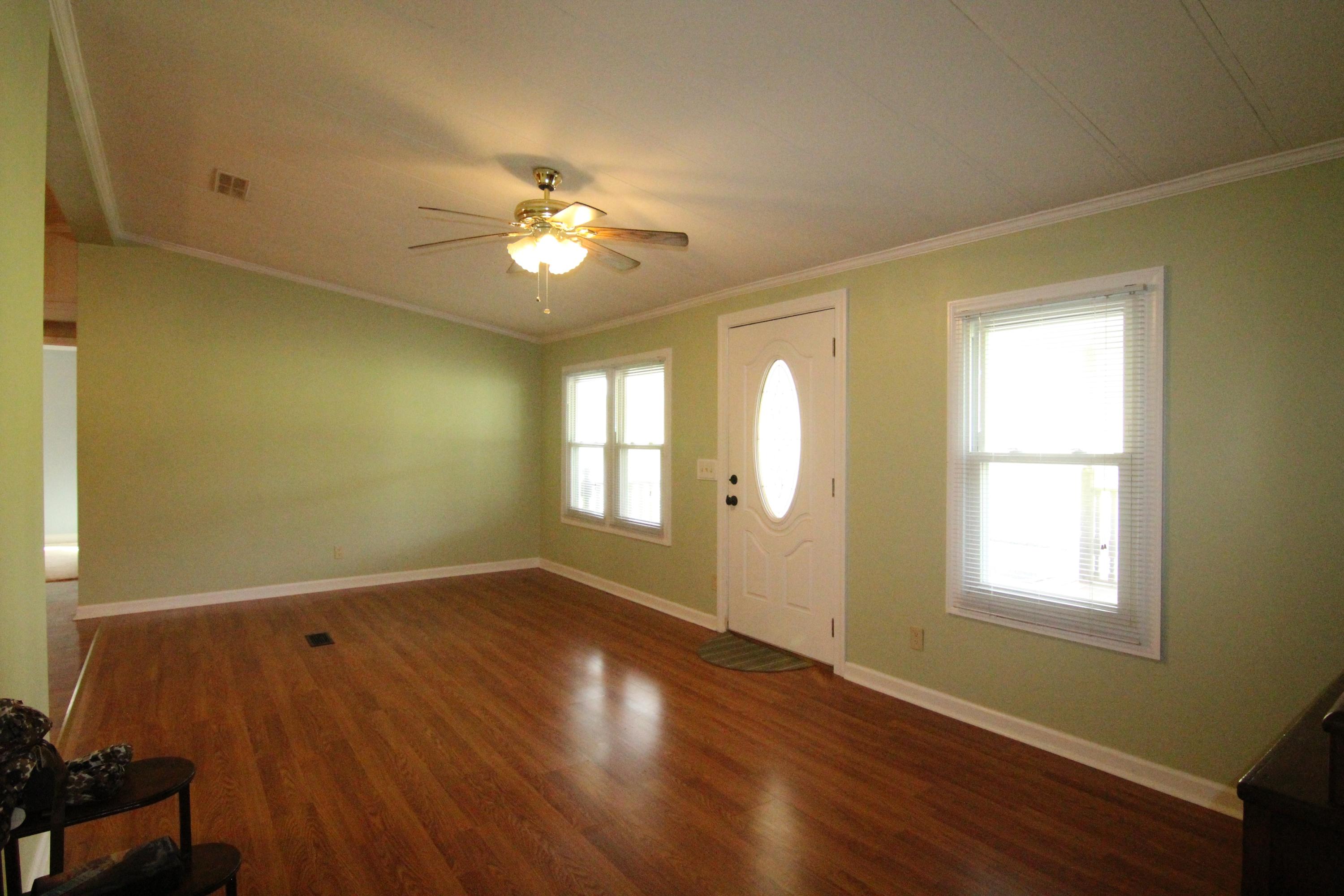 6773 Goodview Road Goodview, VA 24095 - Photo 6 of 43 a view of an empty room with a window and wooden floor