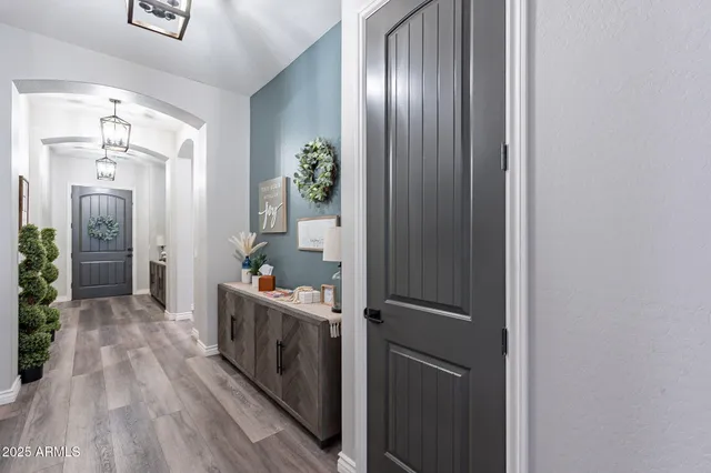 a kitchen with granite countertop kitchen island stainless steel appliances sink dining table and chairs