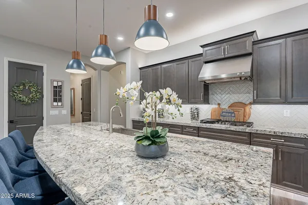 a living room with furniture kitchen and a chandelier