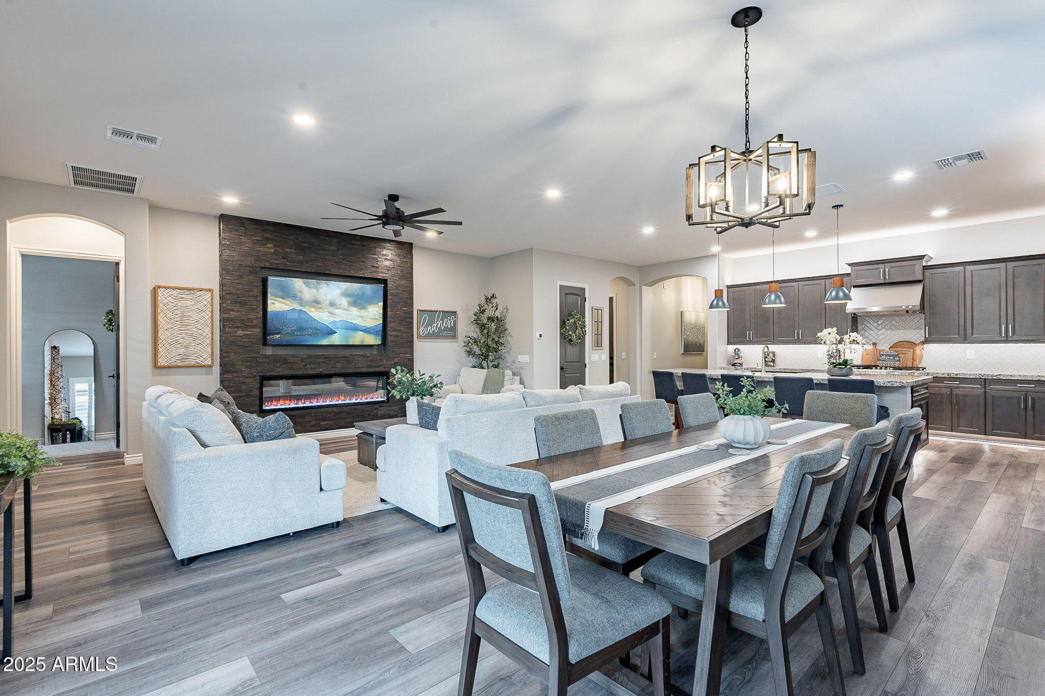 22900 East Reins Road Queen Creek, AZ 85142 - Photo 18 of 74 a view of a dining room with furniture a kitchen and chandelier