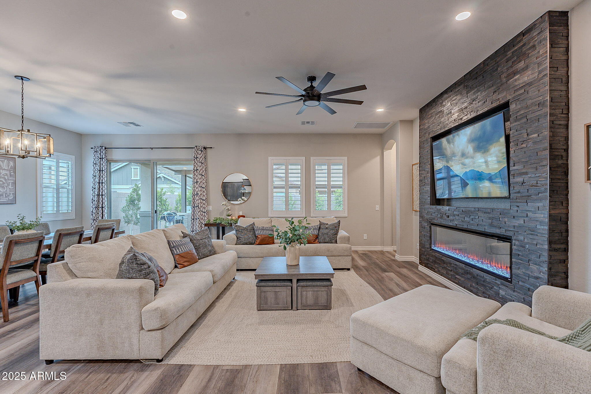 22900 East Reins Road Queen Creek, AZ 85142 - Photo 21 of 74 a living room with furniture a flat screen tv and a fireplace