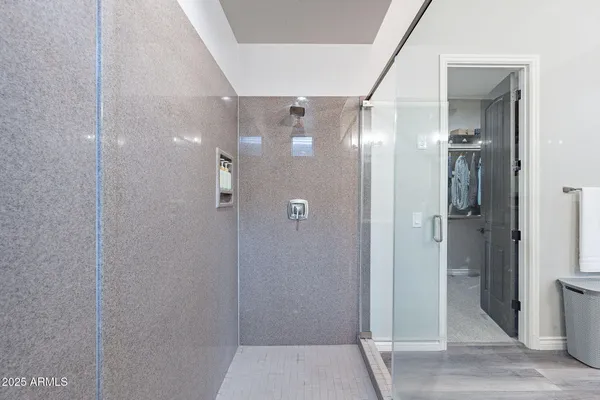 a bathroom with a sink a toilet a mirror and shower