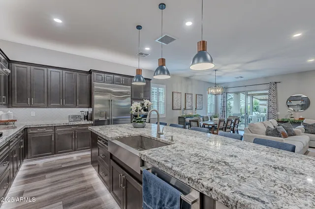 a front view of a house with a garden and mountain view