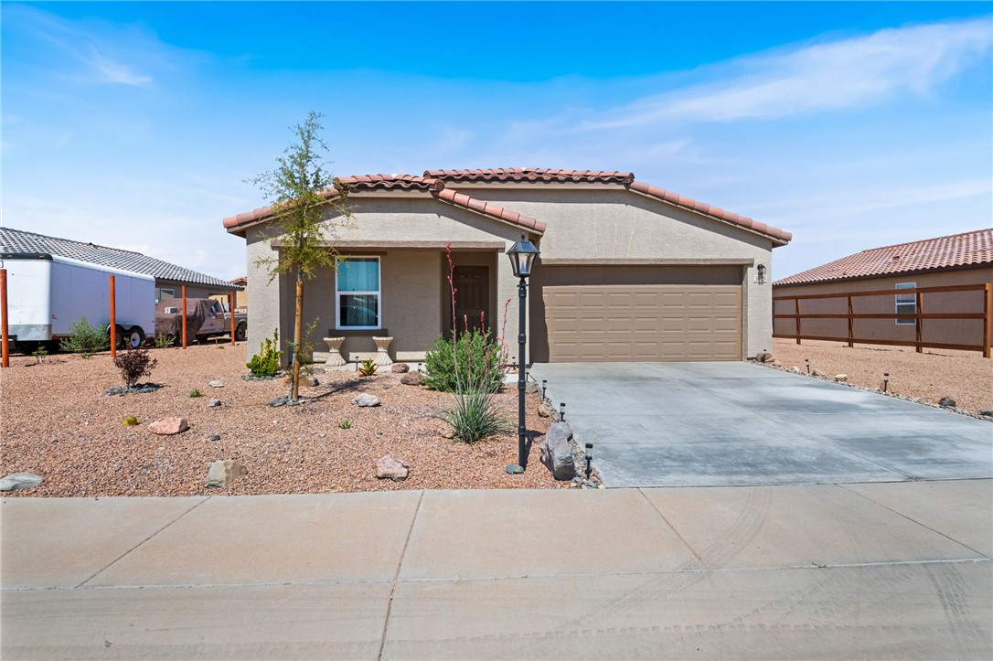 3623 East Andrea Drive Kingman, AZ 86409 - Photo 2 of 40 This property features a stucco exterior with a tile roof, an attached garage, and a concrete driveway