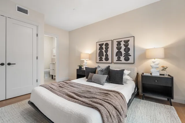 a bedroom with a large bed and a dresser