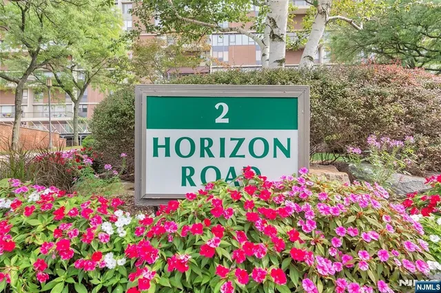 a sign that is in front of flowers