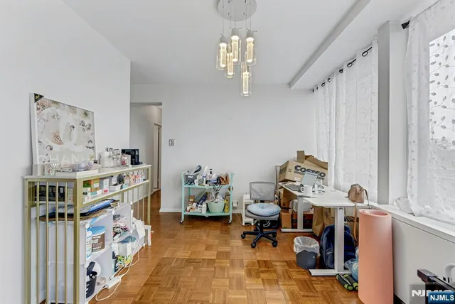 a view of a livingroom with workspace and a window