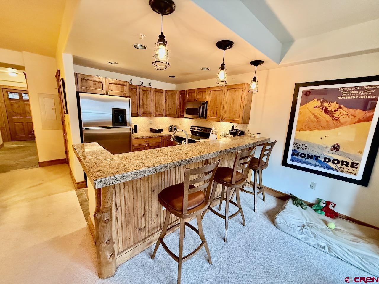 9 Hunter Hill Road, Unit 104 Crested Butte, CO 81225 - Photo 11 of 38 a view of a dining room with furniture and a chandelier