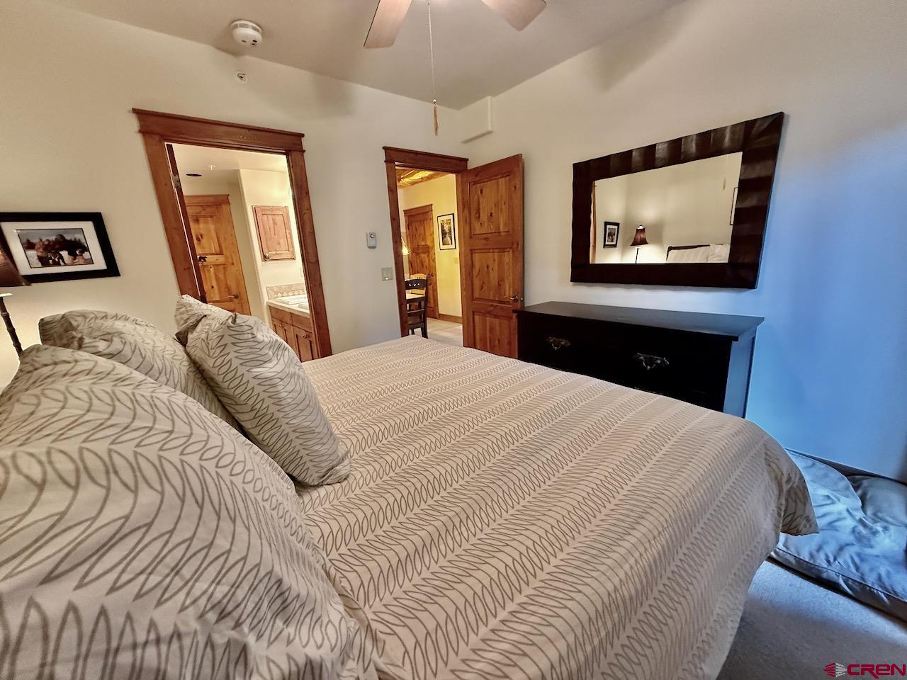 9 Hunter Hill Road, Unit 104 Crested Butte, CO 81225 - Photo 13 of 38 a bedroom with a bed and a painting on the wall